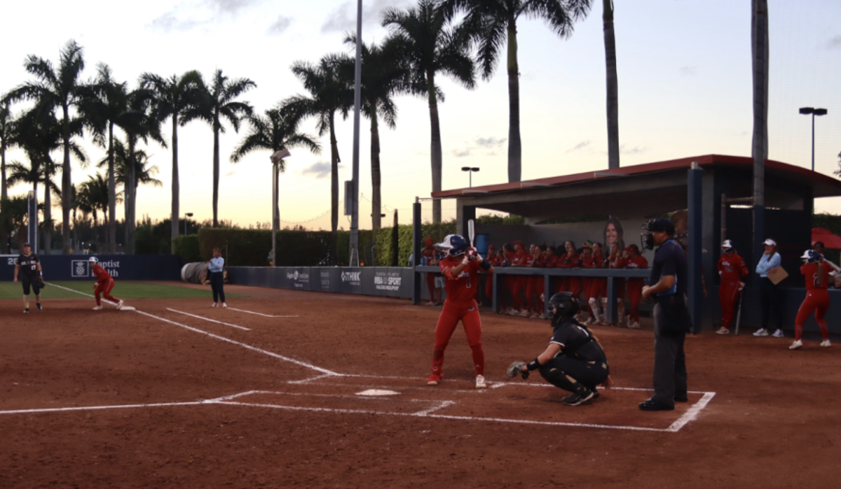 FAU infield Jesiana Mora up to bat while her teammates cheer her on. 